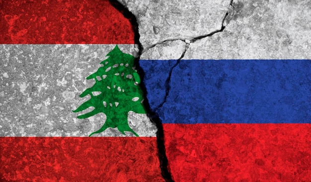 Political relationship between lebanon and russia national flags on cracked concrete background