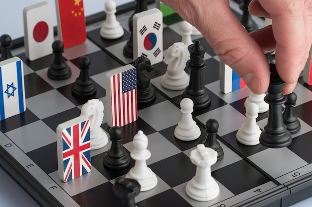 Politician's hand moves a chess piece. Conceptual photo of a political game and strategy.