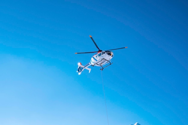 Politiehelikopter die op zonnige dag boven tegen blauwe hemel vliegt