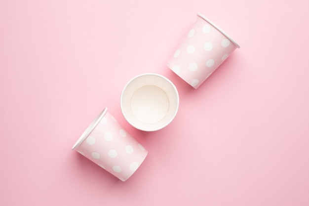 Polka dot disposable paper cups on pink