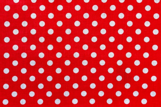 Polka dot on red canvas cotton texture.