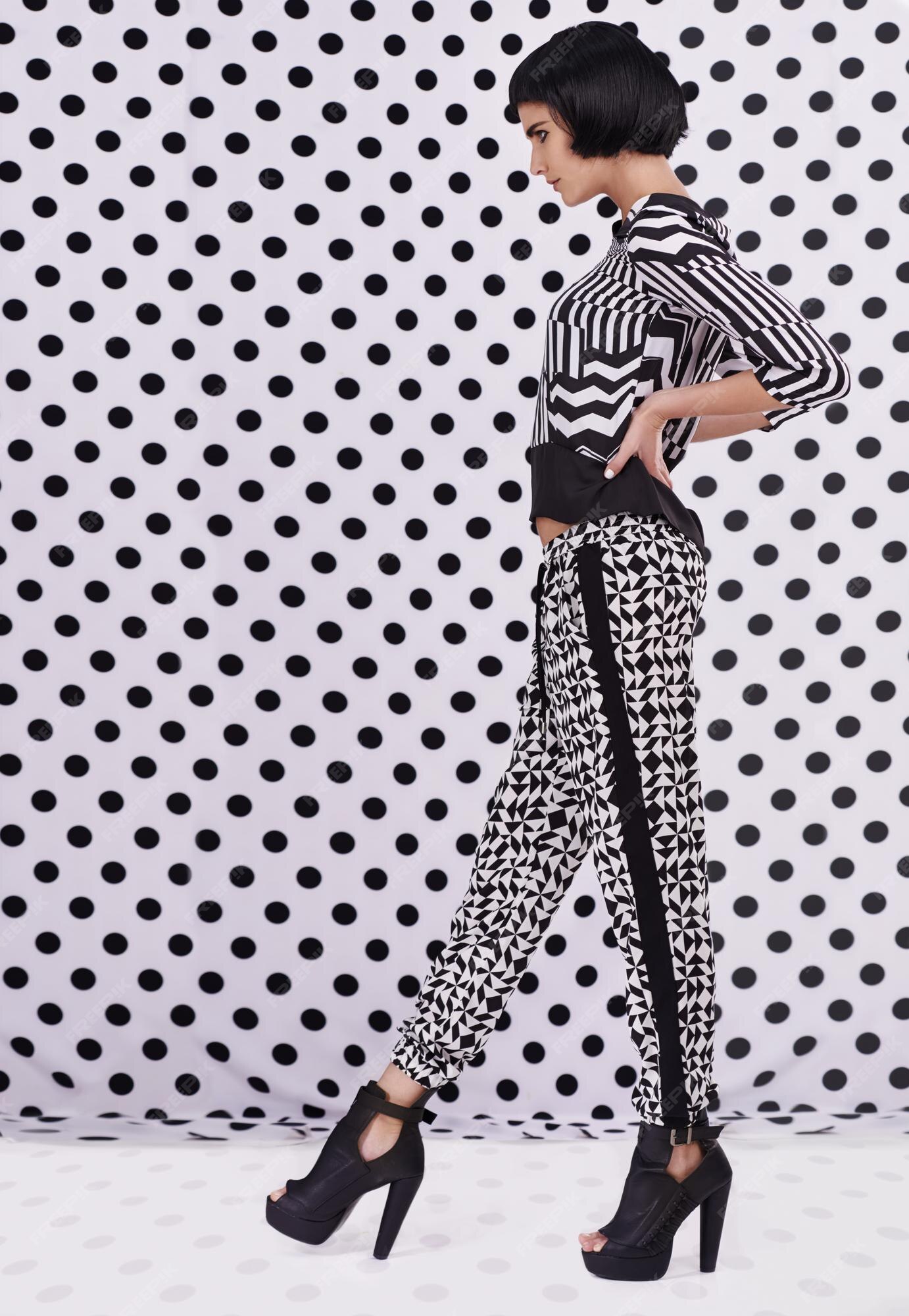 Premium Photo | Polka dot style studio shot of a retrostylish young woman  against a black and white polka dot background