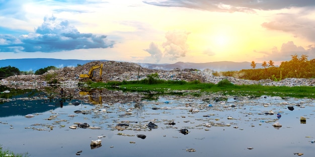 Polluted water and mountain large garbage pile and pollution