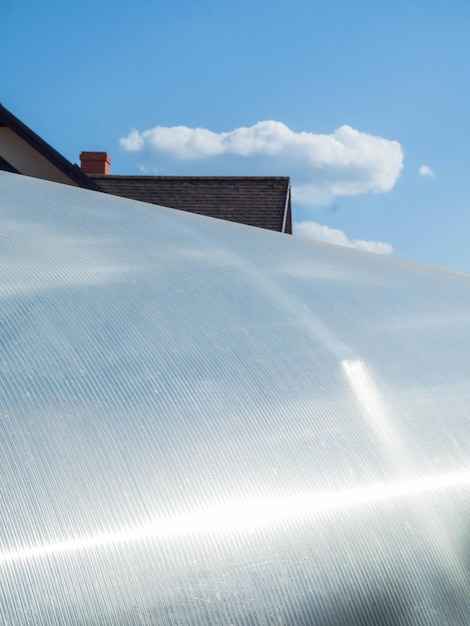 Polycarbonate sheeting as a part of modern greenhouse construction blue sky