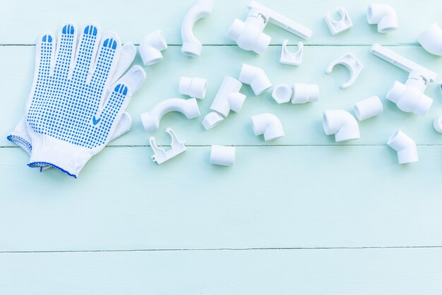 Polypropylene pipes, couplings, corners and fasteners on a blue background. copy space.