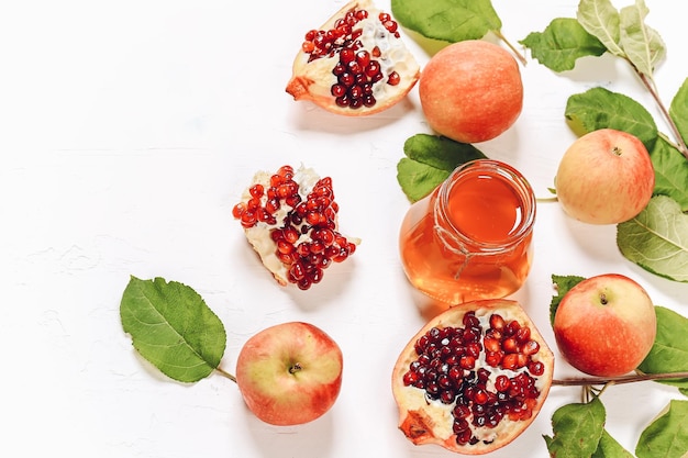 Pomegranate apples and honey Autumn composition Traditional Jewish holiday New Year Happy Rosh Hashanah