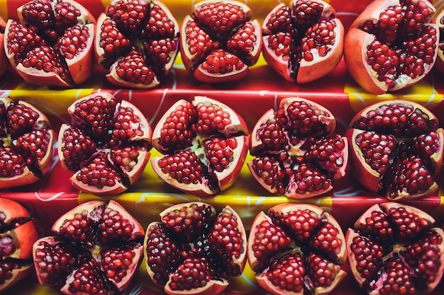 Pomegranate background, red pomegranate cut in half.