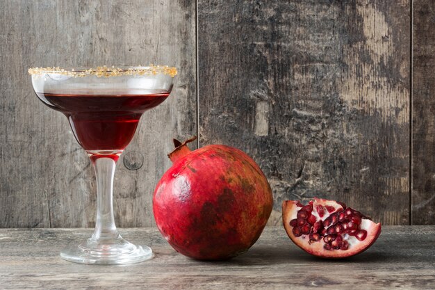 Pomegranate cocktail on wooden background