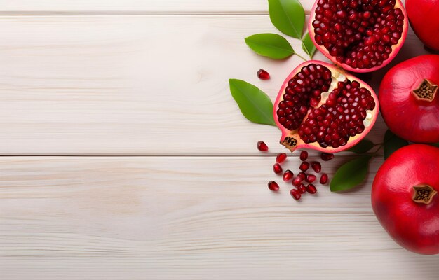 Pomegranate fruit riped heart shape and leaves on white wooden t