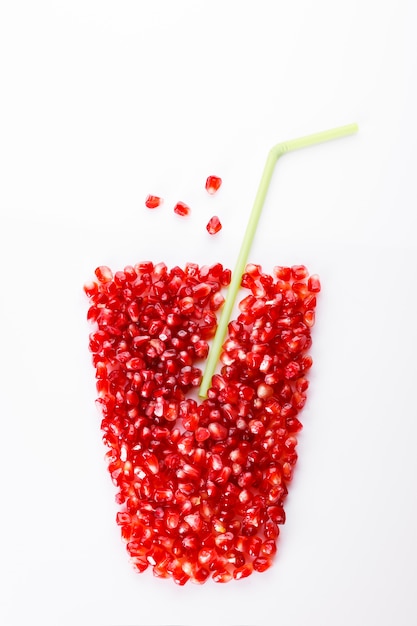 Pomegranate fruit with seeds on white 