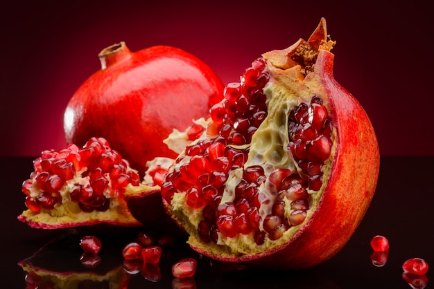 Pomegranate fruits on red background