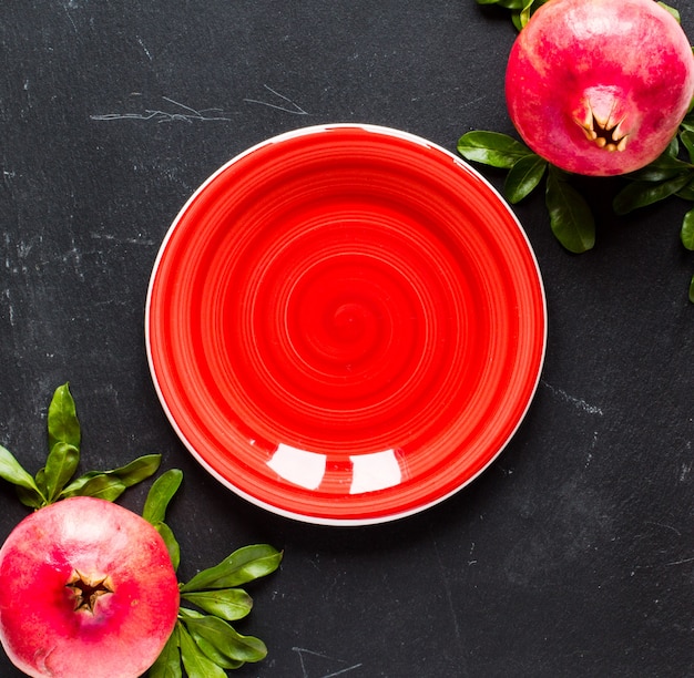 Pomegranate fruits on rustic wood table