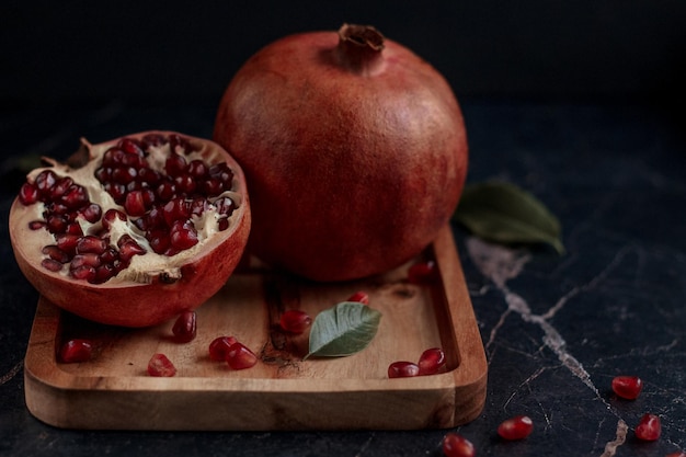 Pomegranate fruits on the wooden board