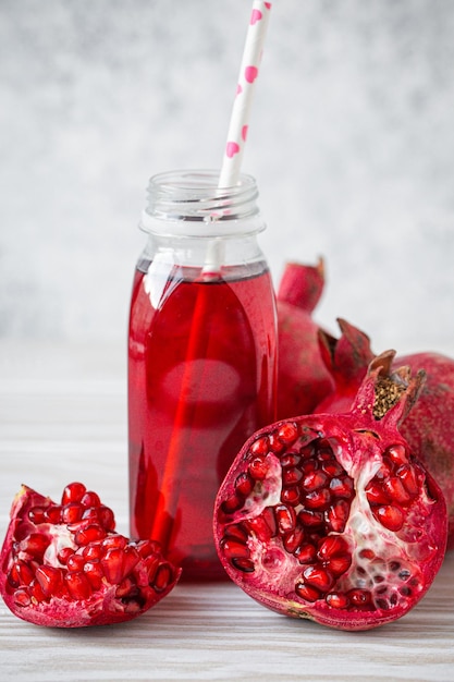 Pomegranate juice in bottle and fruit