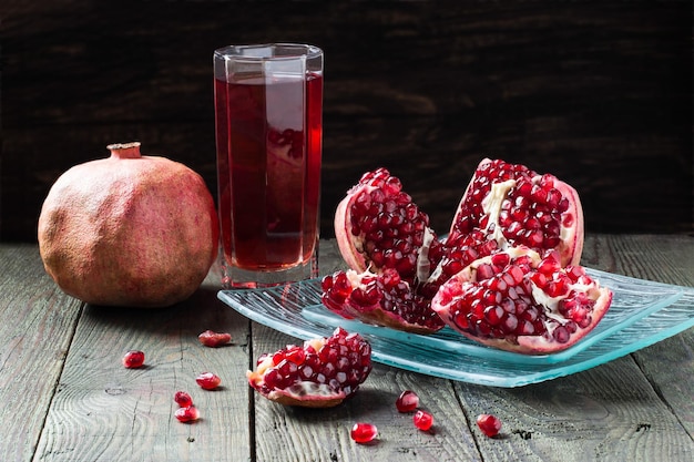 Pomegranate juice and slices of pomegranate with grains