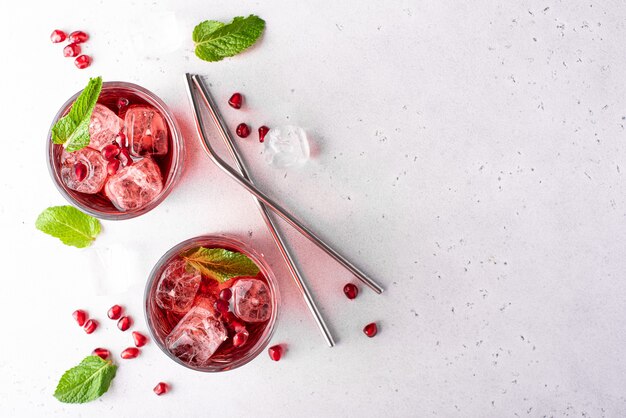 Pomegranate juice with pomegranate seeds, mint and ice