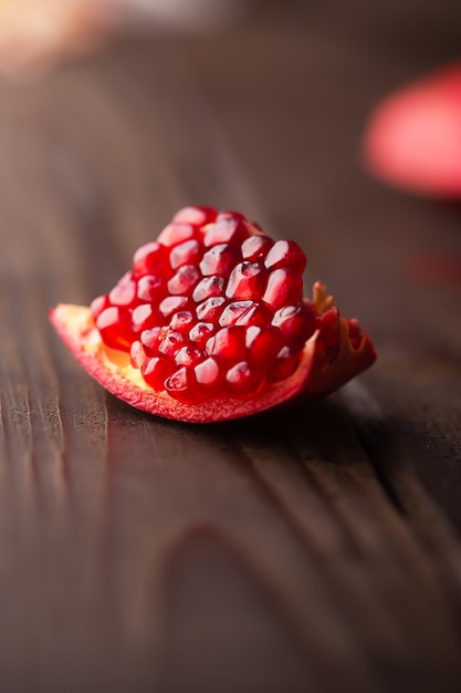 Pomegranate piece on a dark wooden table