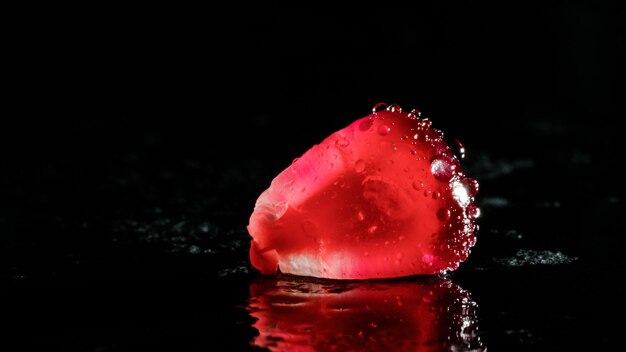 Pomegranate seed on a black background closeup plan