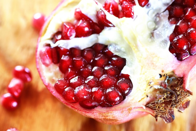 Pomegranate seed on wood background