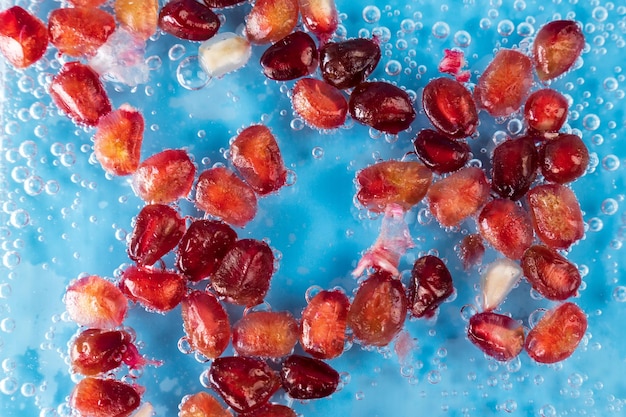 Pomegranate seeds Background of pomegranate berries closeup in water