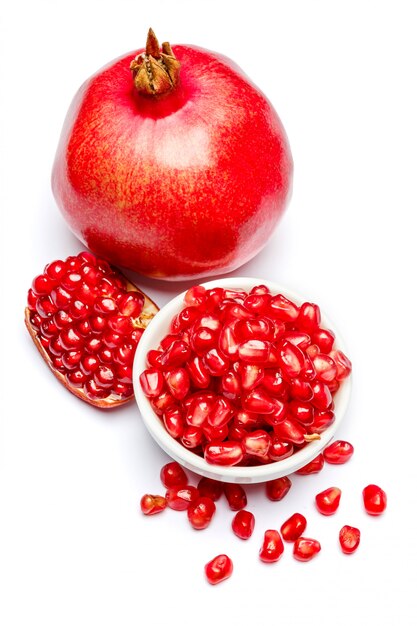 Pomegranate and seeds in ceramic bowl