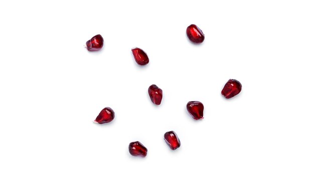 Pomegranate seeds on white background