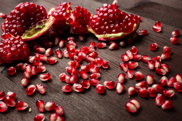 Pomegranate seeds on a wooden table