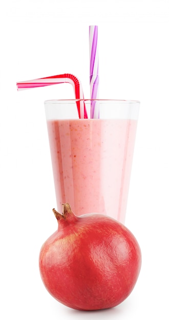 Pomegranate smoothie or yogurt in glass with straw and pomegrana