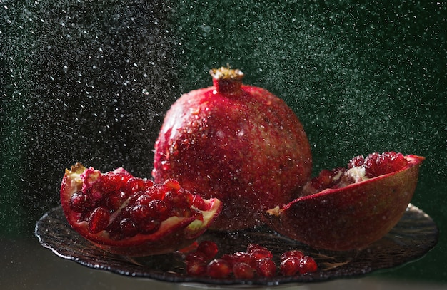 Pomegranate in spray of water.