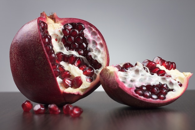 Pomegranate on the table over grey background