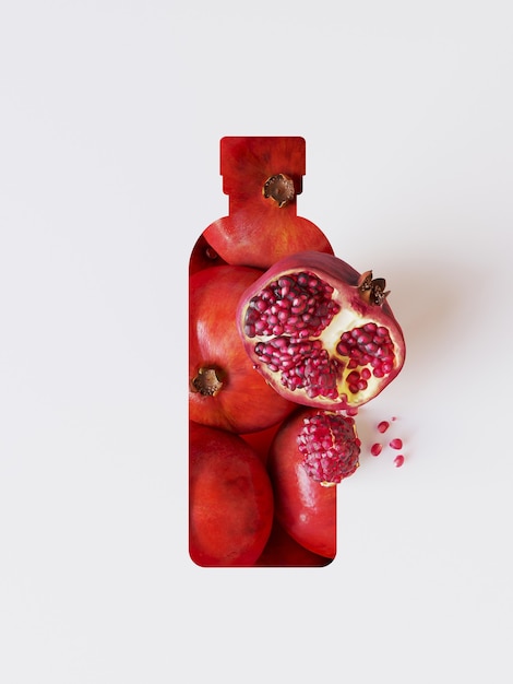 Photo pomegranate underlay with paper cut shape of bottle.