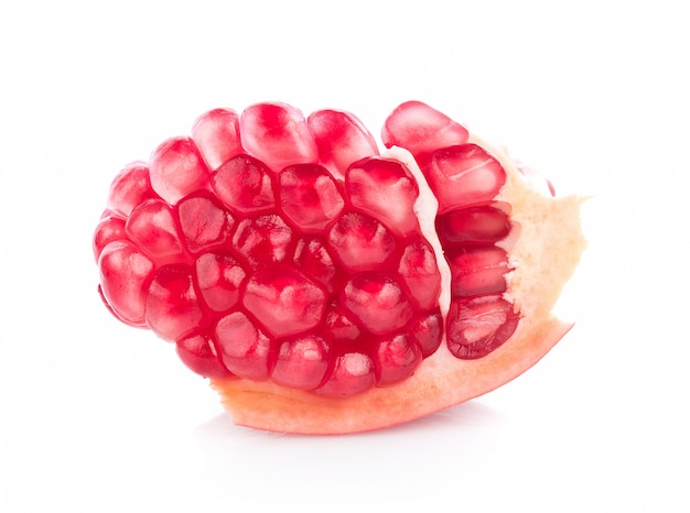 Pomegranate on white wall