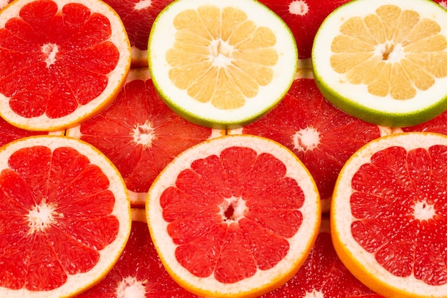 Pomelo and grapefruit juicy slices background