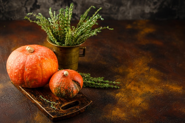 Pompoen, basilicum en tijm op een roestige tafel