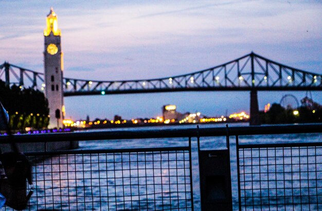 Pont jacques cartier over st lawrence river against sky at dusk