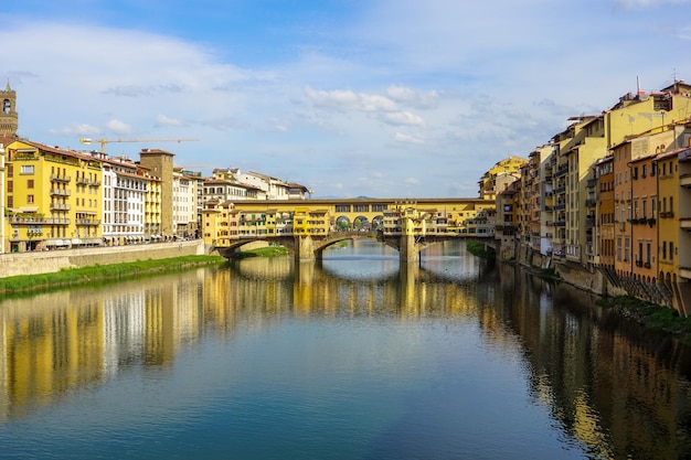 Ponte vecchio over arno river against sky in city