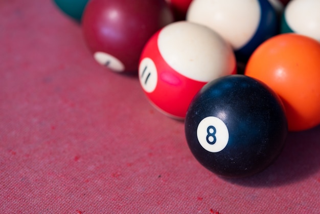 Pool balls on red felt table.