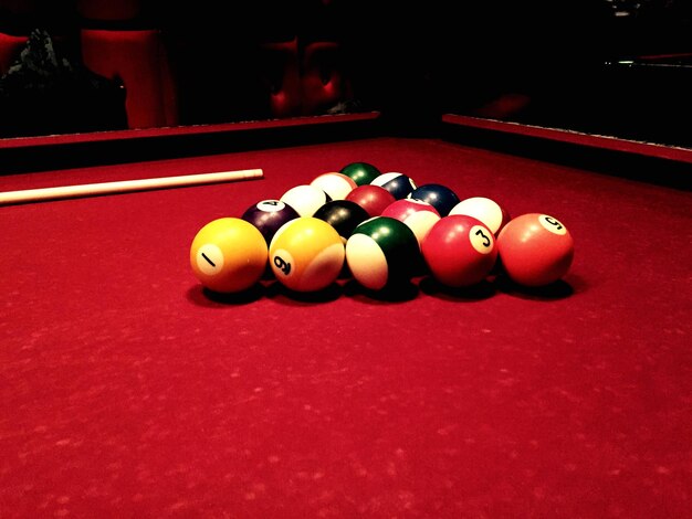 Pool balls with cue on table