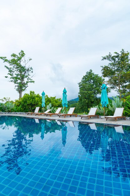 Pool bed around swimming pool with mountain hill background