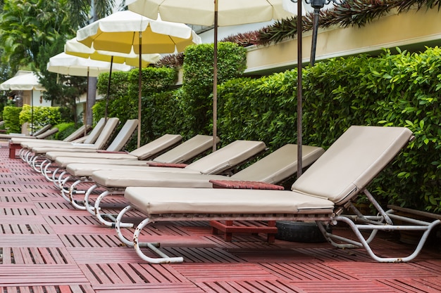 Pool chair side of swimming pool background