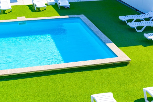 Pool design in a modern residence Sunny weather sun beds Vacation