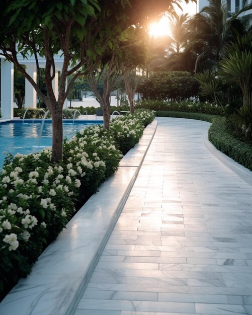 The pool is lined with white flowers and the sun is shining through the trees.