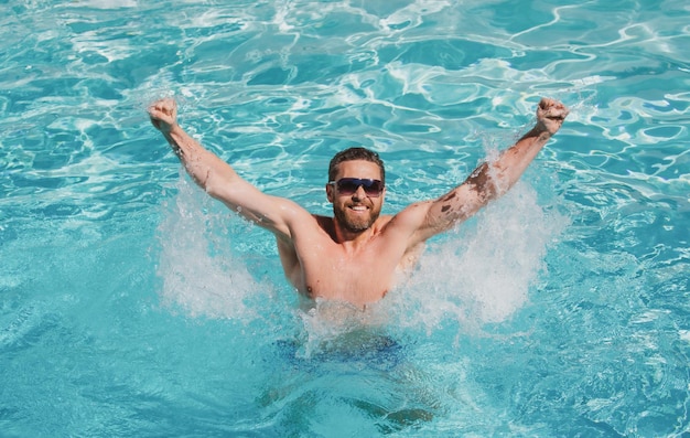 Pool resort guy in water happy man in swimming pool summertime vacation summer man