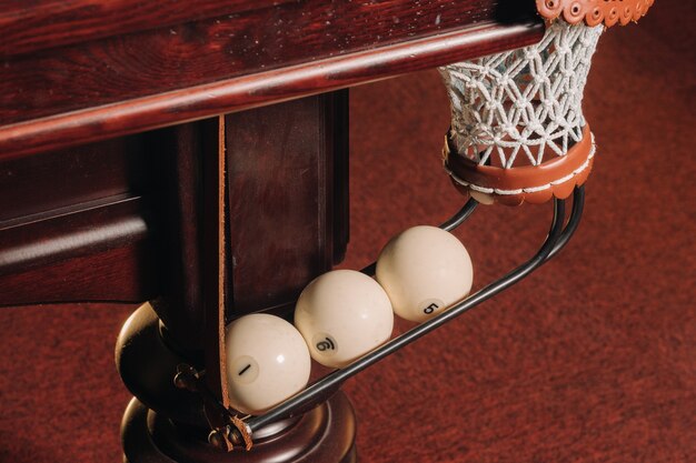 A pool table with balls that have already been played in the pool club