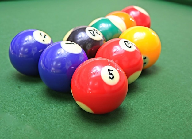 A pool table with a red ball and the number 5 on it