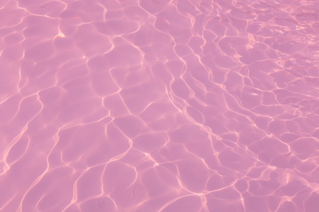 Beautiful pink water in swimming pool texture background Stock Photo