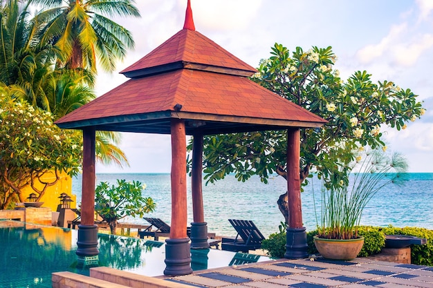 Pool with a roof from the sun on the seashore among tropical plants Rest and relaxation