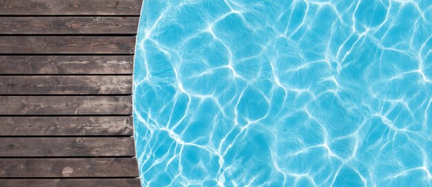 Poolside wooden deck and blue water of pool