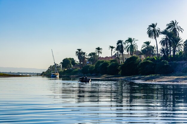 Poor egyptian fishermen in boat on the Nile river