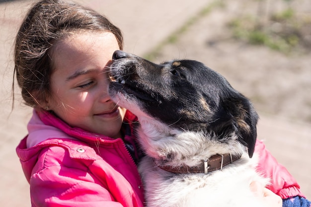 Poor little girl with a dog in village